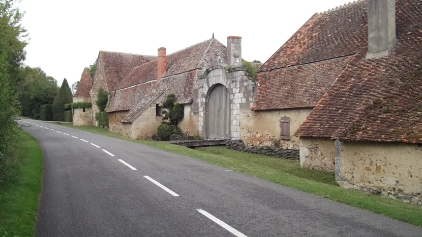 A quiet country road past the old stone buildings of the priory at Orsan, on Route 4
